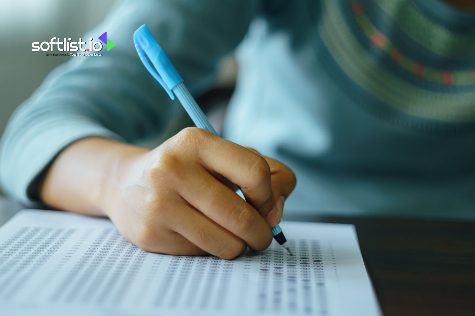 A person filling out a form or test with a blue pen