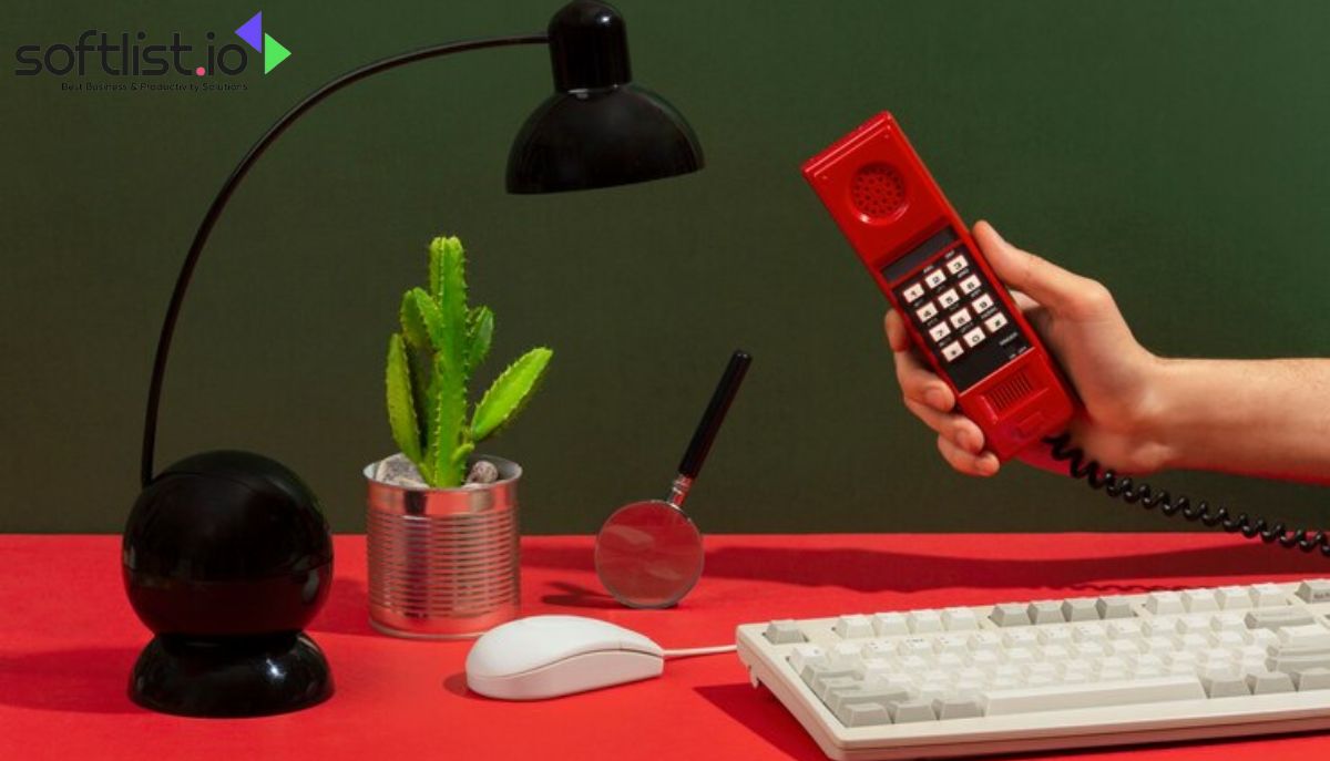 A hand holding a red telephone, symbolizing the rise of VoIP in home communications.