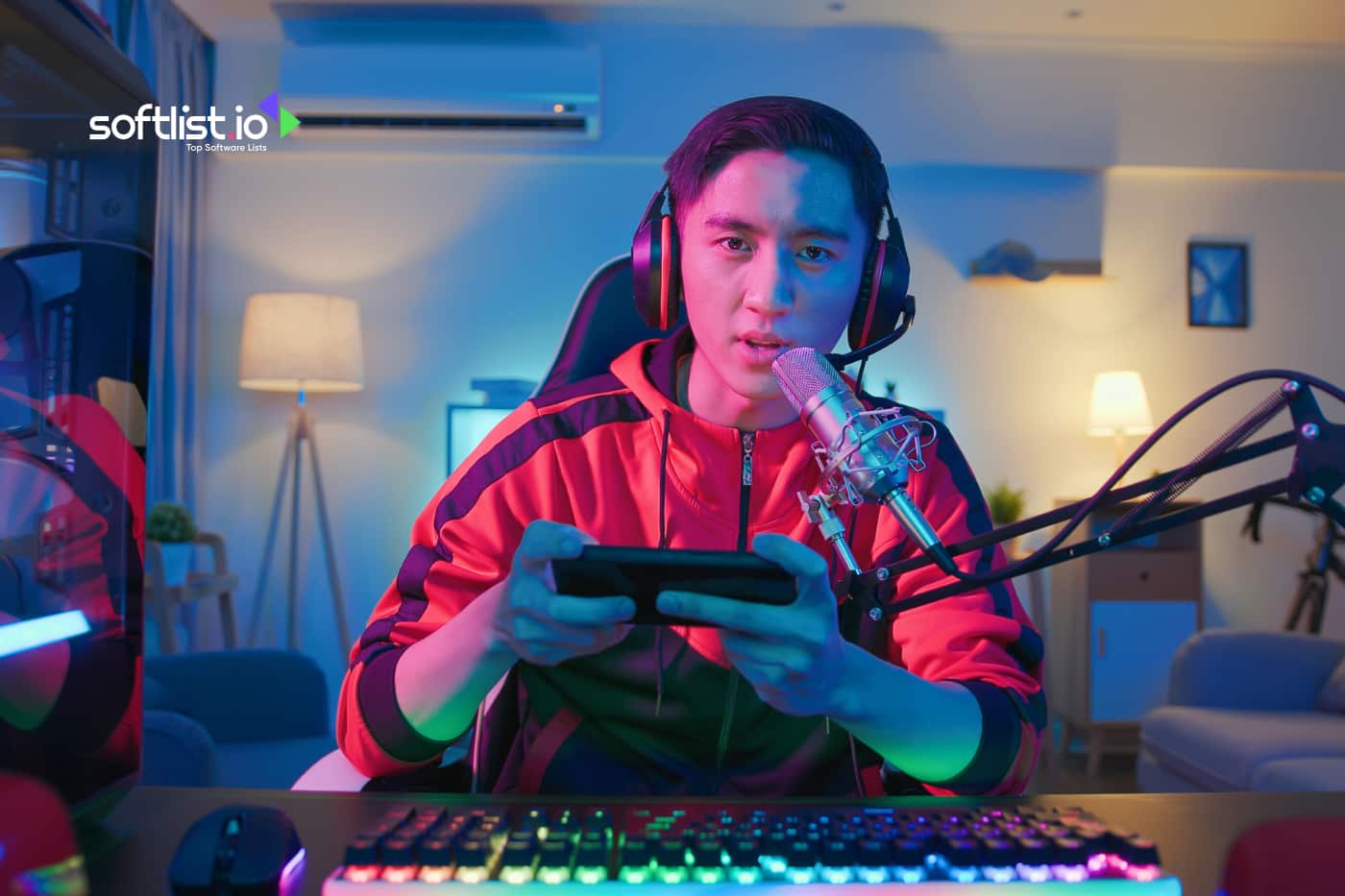 a gamer holding his gaming phone and mic