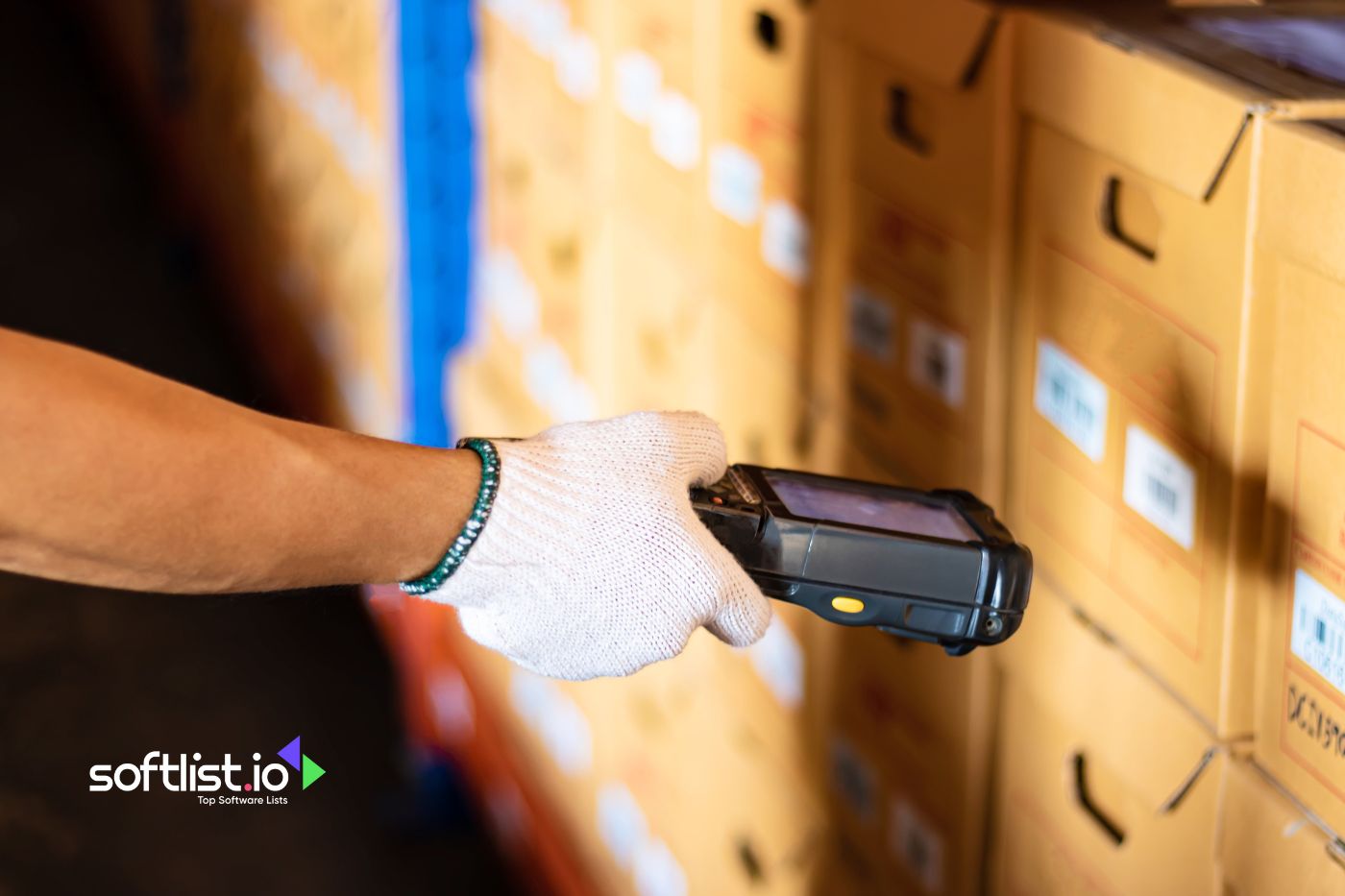 Worker scanning warehouse boxes with handheld device