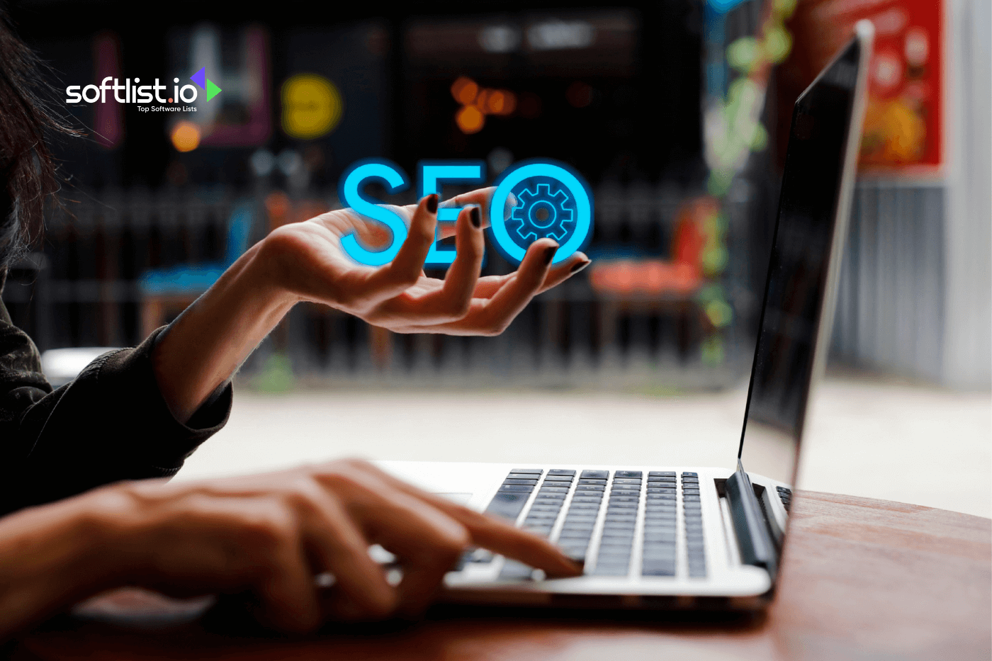 a hand typing on laptop and an SEO text on the hand