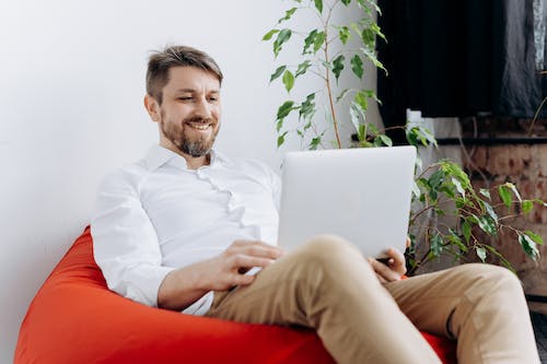 Free A Happy Man Using His Laptop Stock Photo