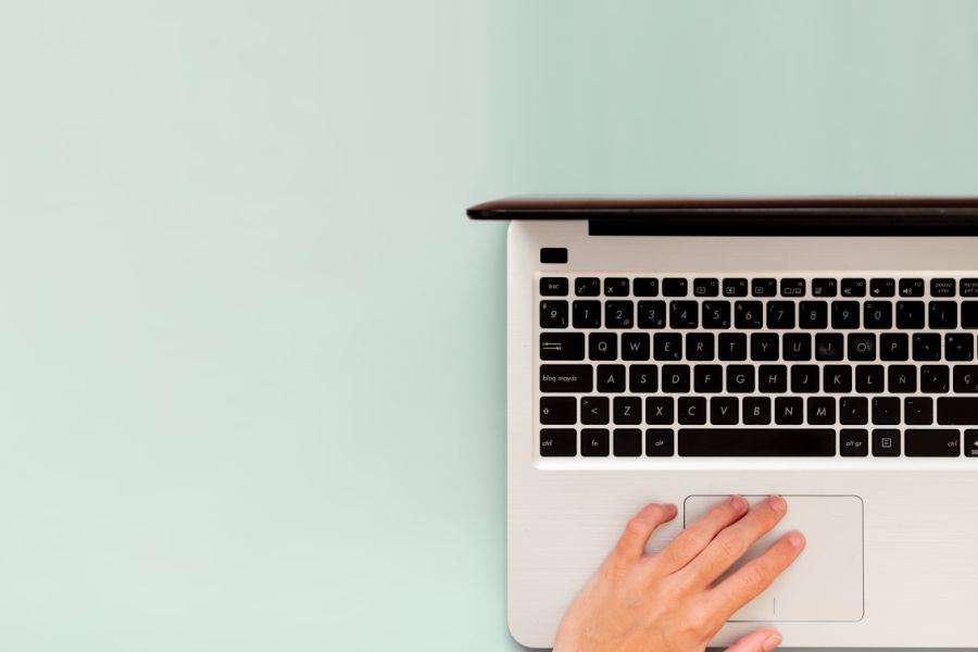 A hand on a computer keyboard