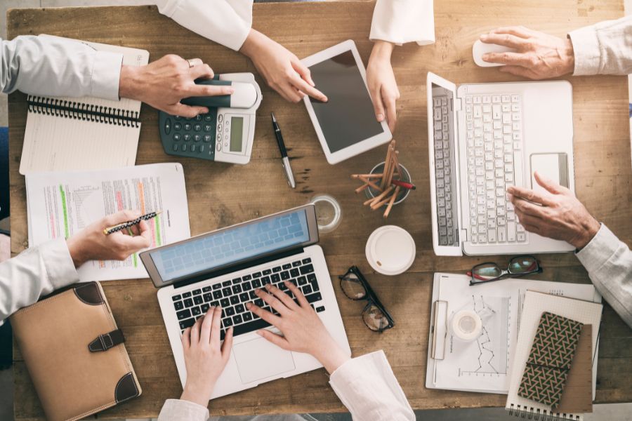 A group of people working on laptops and tablets