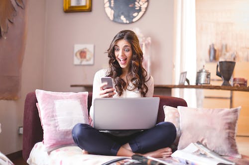 Free Woman Sitting While Using Cellphone Stock Photo