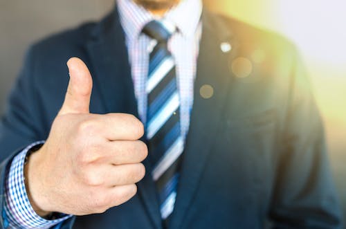 Free Close-up Photo of Man Wearing Black Suit Jacket Doing Thumbs Up Gesture Stock Photo