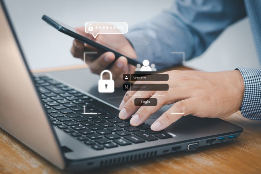Person using laptop and smartphone with login and security icons overlayed.