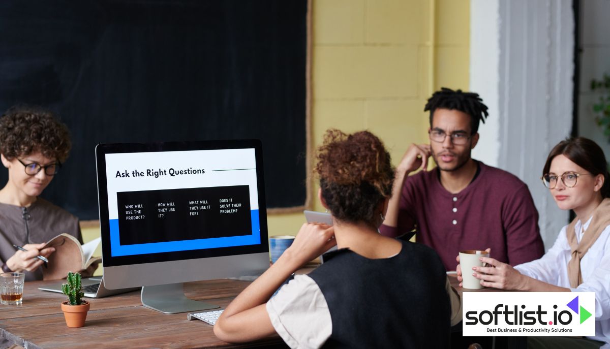 A group of educators sitting around a table discussing how to sell an online course.