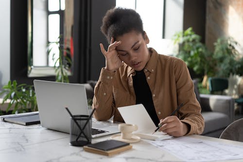 Free A Woman Writing on a Notebook  Stock Photo