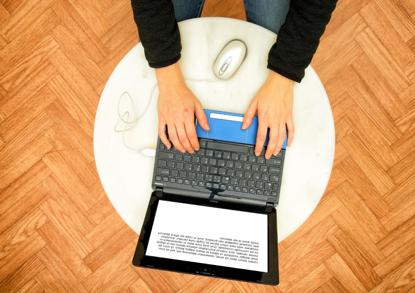 Person typing on the laptop