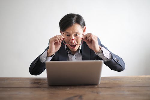 Free Amazed formal male looking at laptop screen Stock Photo